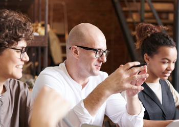 retaining top talent banner image of people round meeting room table